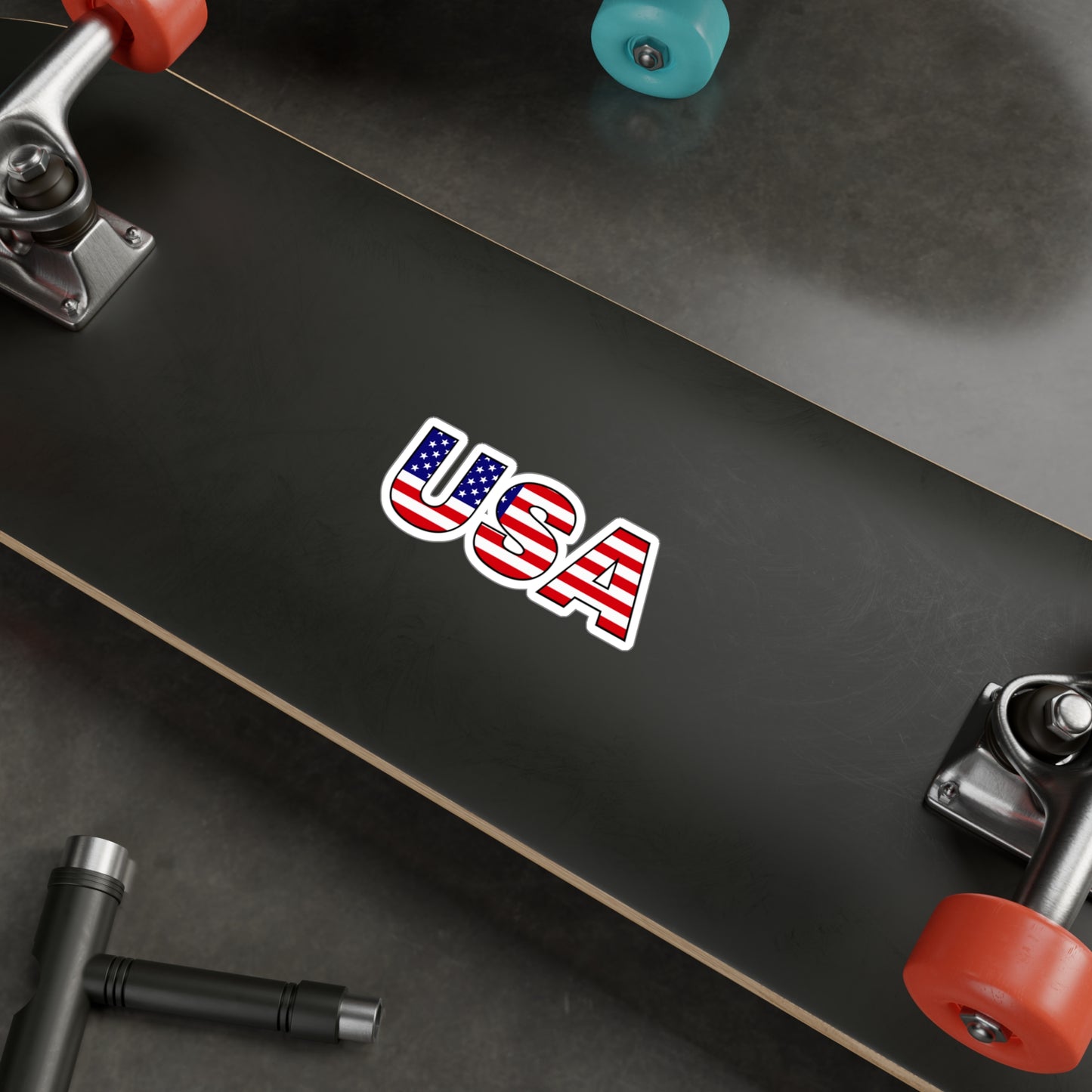 USA colored USA letters vinyl car decal displayed on a skate board