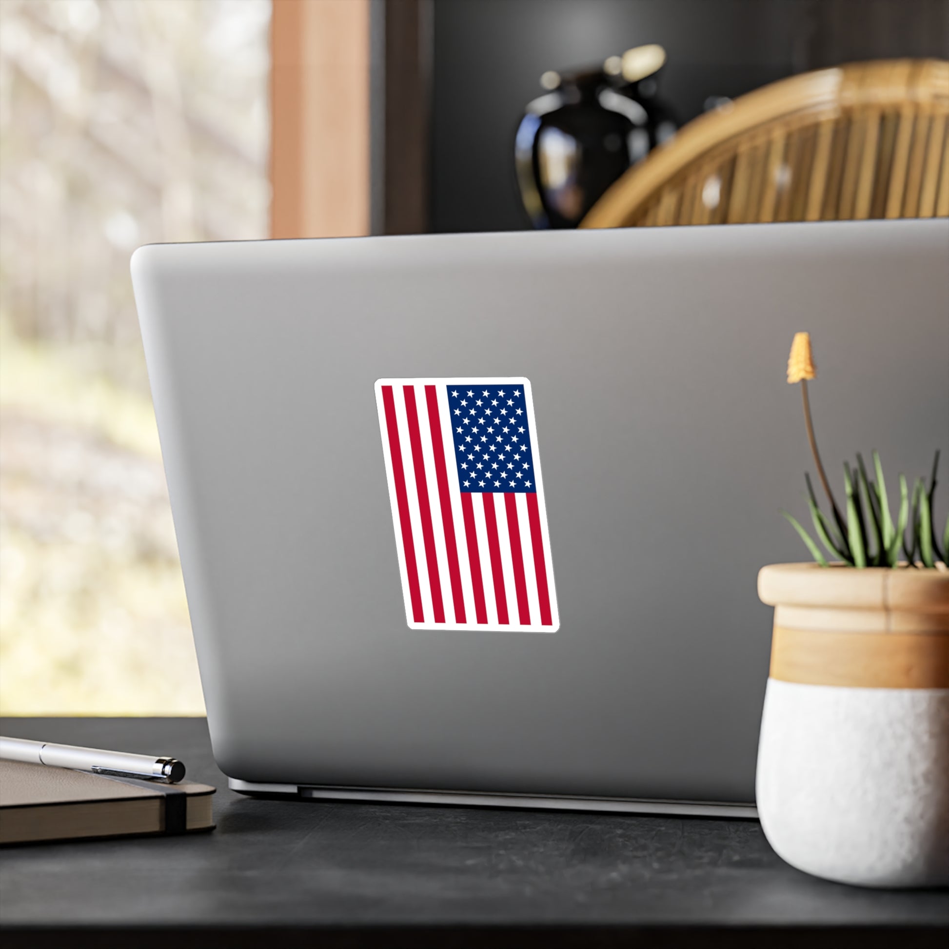 A USA flag sticker displayed on the back of a laptop