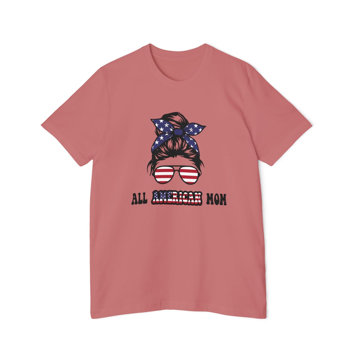 Pink T-shirt with 'All American Mom' text in black and American flag colors, featuring a graphic of a woman’s hair in a bun with a stars and stripes bandana and sunglasses