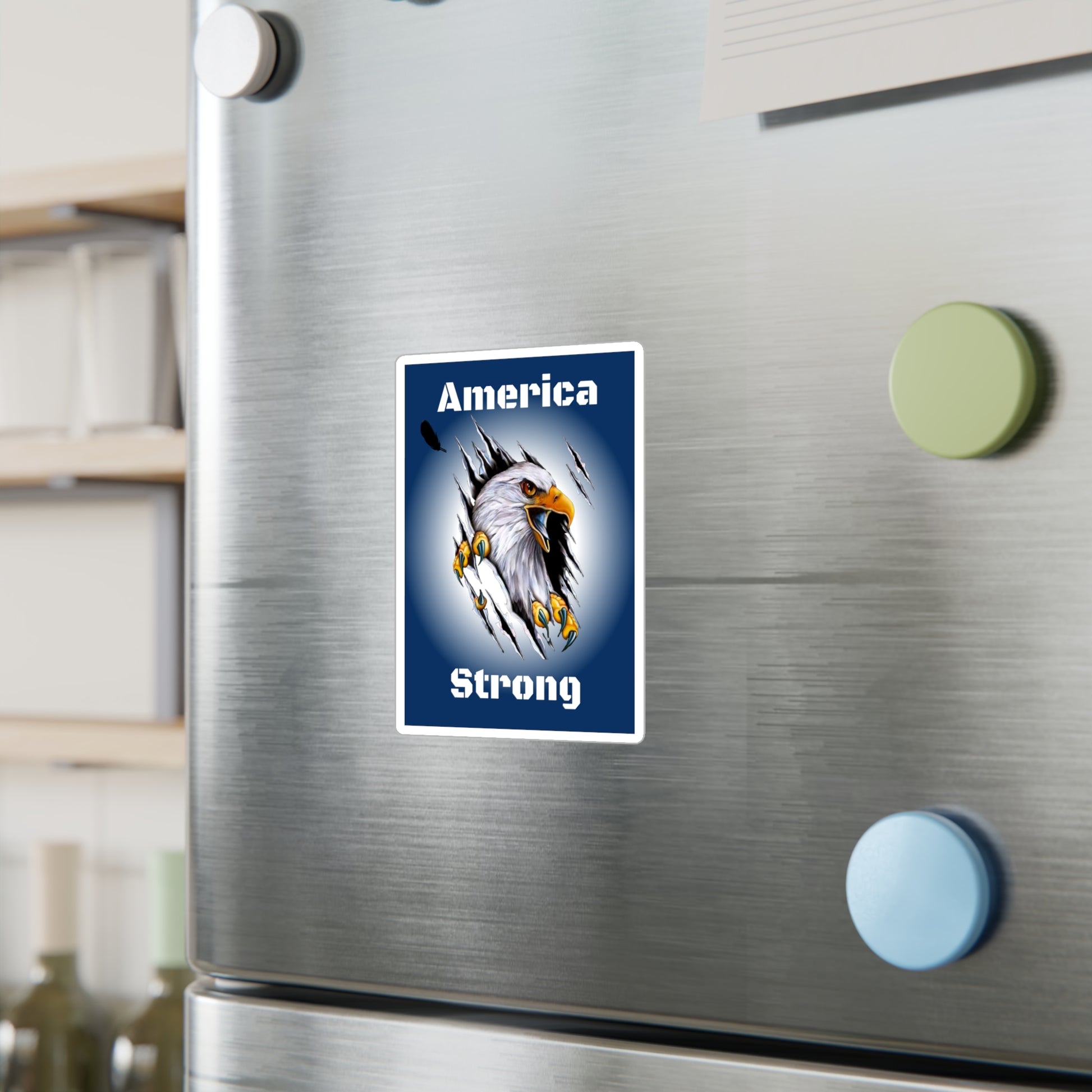 Blue decal showing an eagle ripping through the middle of the design with the words, "America Strong", around the eagle being displayed on a wall.