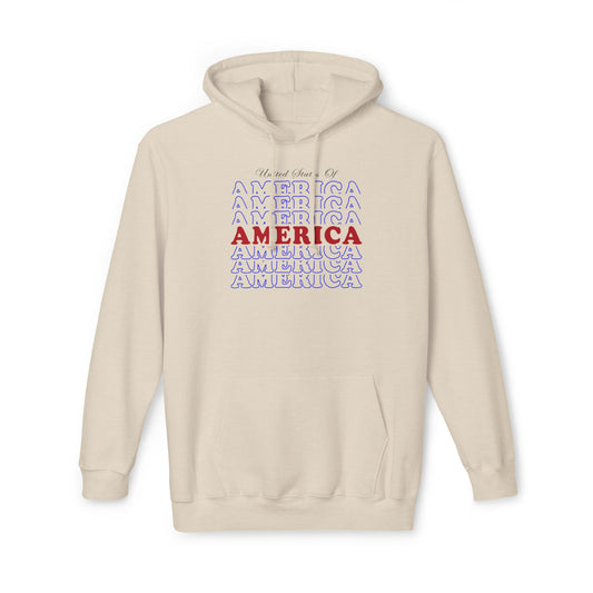 Cream hoodie with a repeating 'America' text design in blue, with the central 'America' text in bold red. The phrase 'United States Of' is written in a cursive style above the text