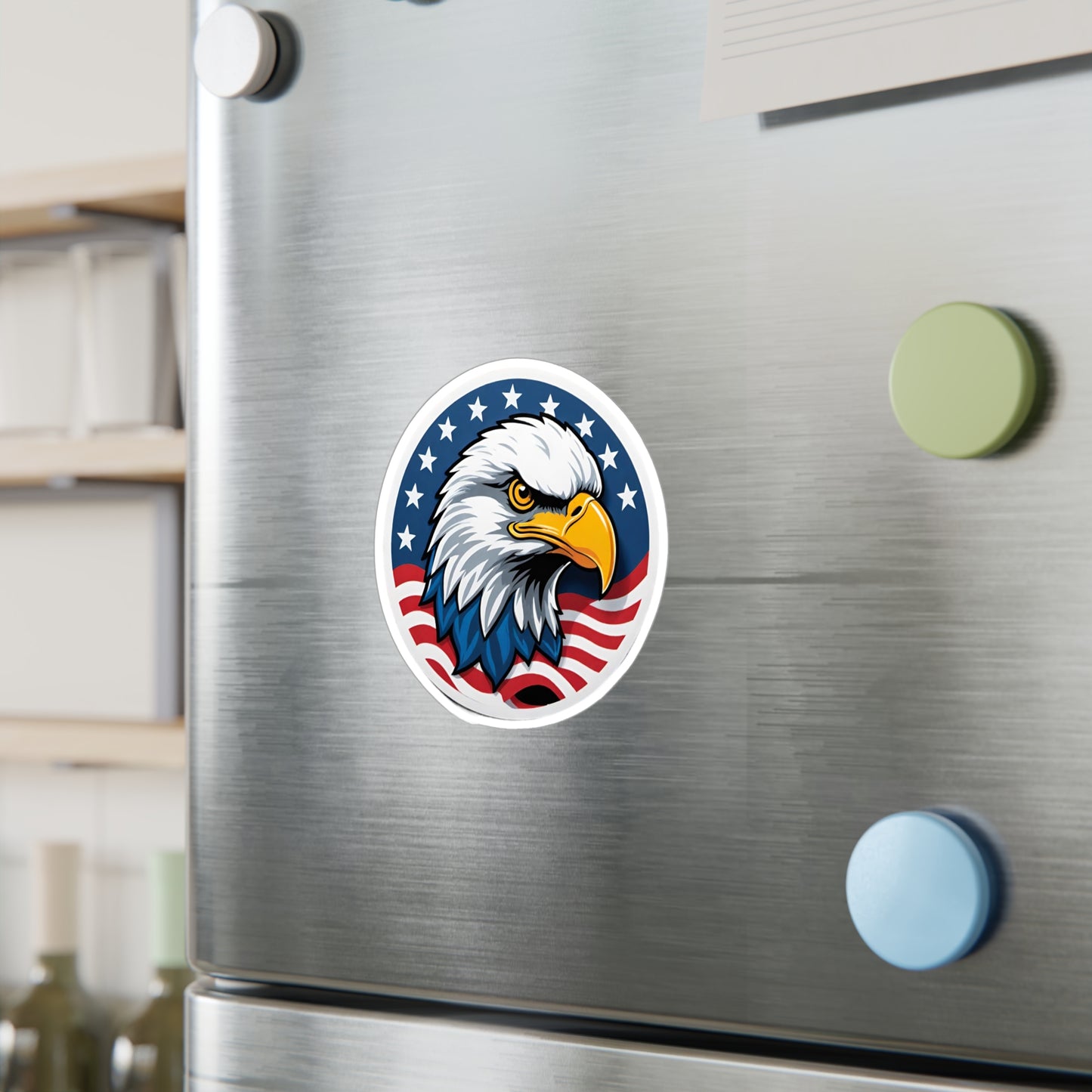 Round patriotic sticker featuring a bold illustration of a bald eagle with a sharp, determined expression. The eagle is set against a background of stars and stripes, symbolizing the American flag displayed on a wall