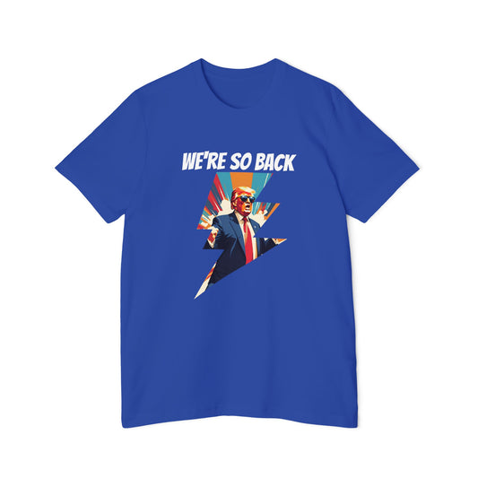 Blue T-shirt featuring a dynamic graphic design with a stylized image of Donald Trump in a suit and red tie, standing with his arms outstretched. Above the image, the text reads 'WE'RE SO BACK' in bold white letters