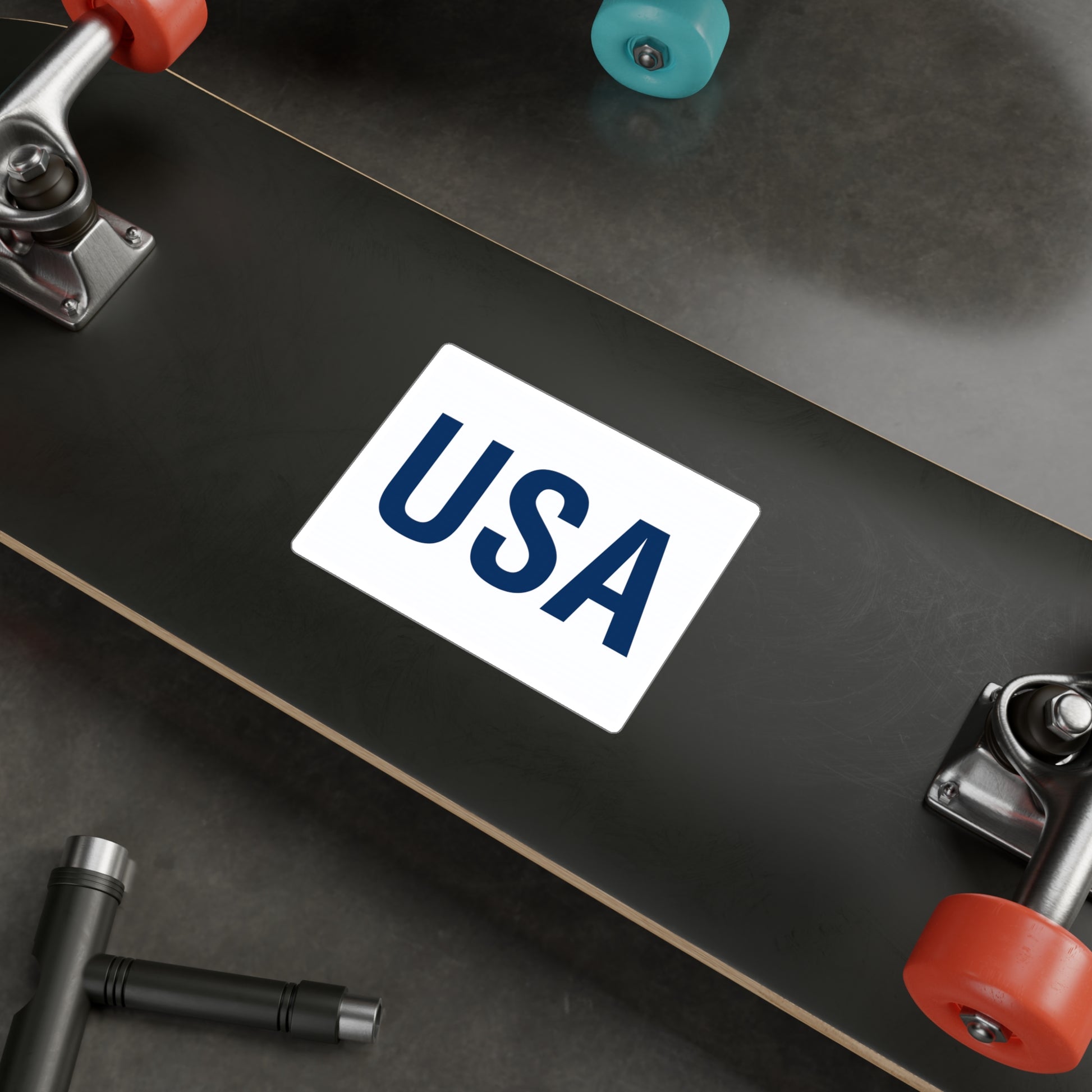 Blue USA letters sticker displayed on a skate board