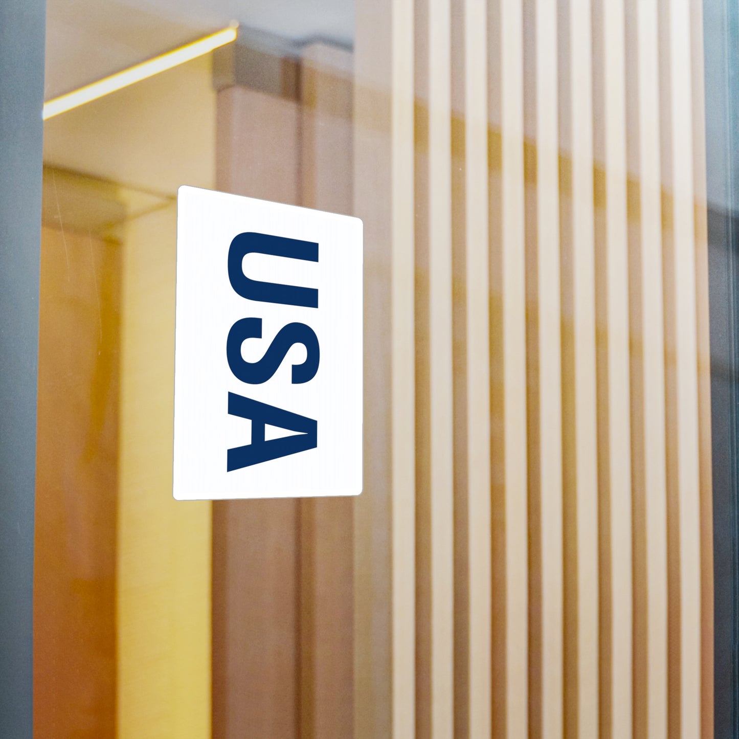 Blue USA letters sticker displayed on a window