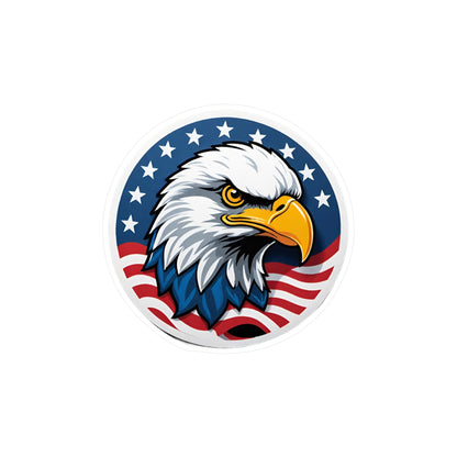 Round patriotic sticker featuring a bold illustration of a bald eagle with a sharp, determined expression. The eagle is set against a background of stars and stripes, symbolizing the American flag.