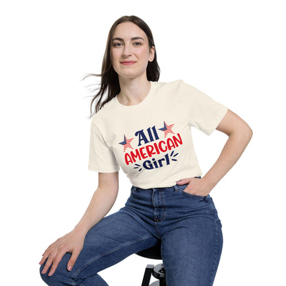 Woman wearing a beige T-shirt with 'All American Girl' text in red and blue, featuring two American flag stars above the text.