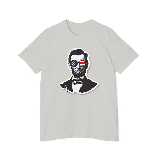 Light gray T-shirt featuring a stylized portrait of Abraham Lincoln wearing sunglasses with the American flag reflected in the lenses