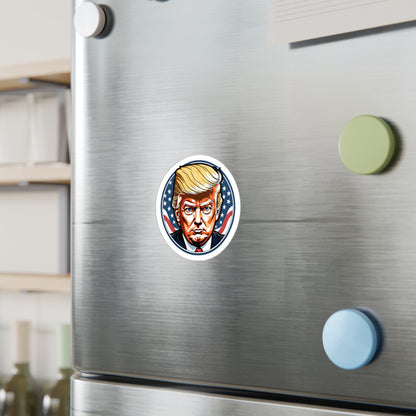 Round sticker featuring a bold, graphic illustration of a determined figure with distinctive golden hair. The background showcases stars and stripes, symbolizing the American flag, adding a patriotic theme to the design displayed on a wall