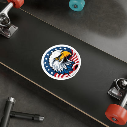 Round patriotic sticker featuring a bold illustration of a bald eagle with a sharp, determined expression. The eagle is set against a background of stars and stripes, symbolizing the American flag displayed on a skate board