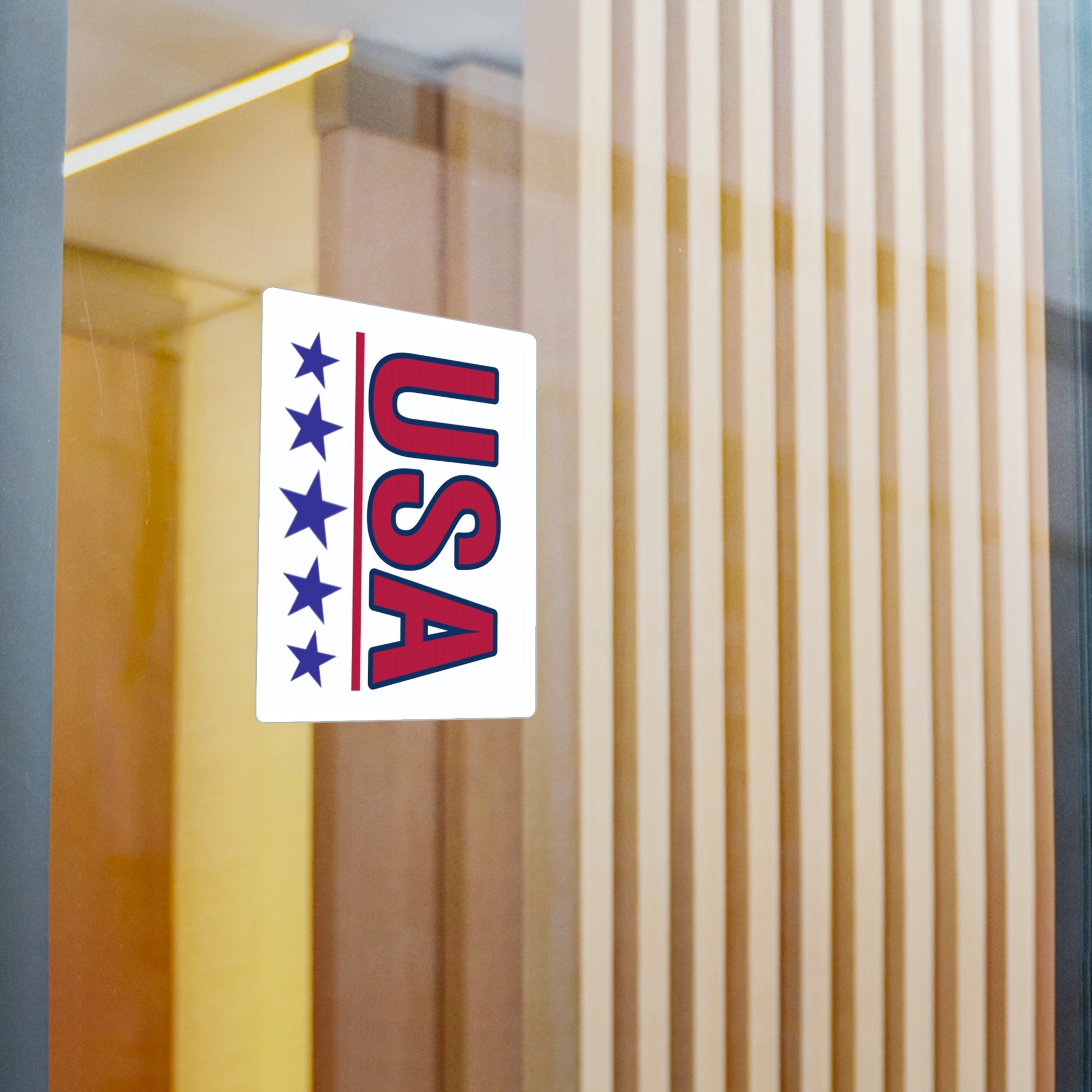 Red USA letters with 5 blue stars underneath car vinyl decal displayed on a window